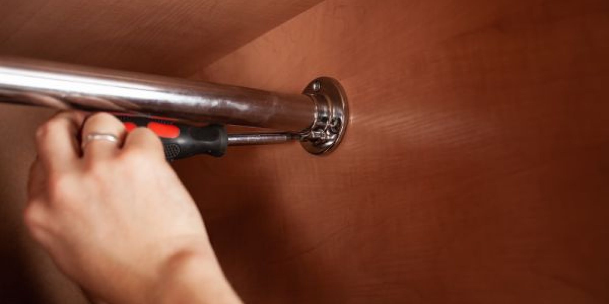 a-man-twists-a-pipe-for-a-hanger-in-a-closet-with-2025-01-08-20-40-00-utc-1