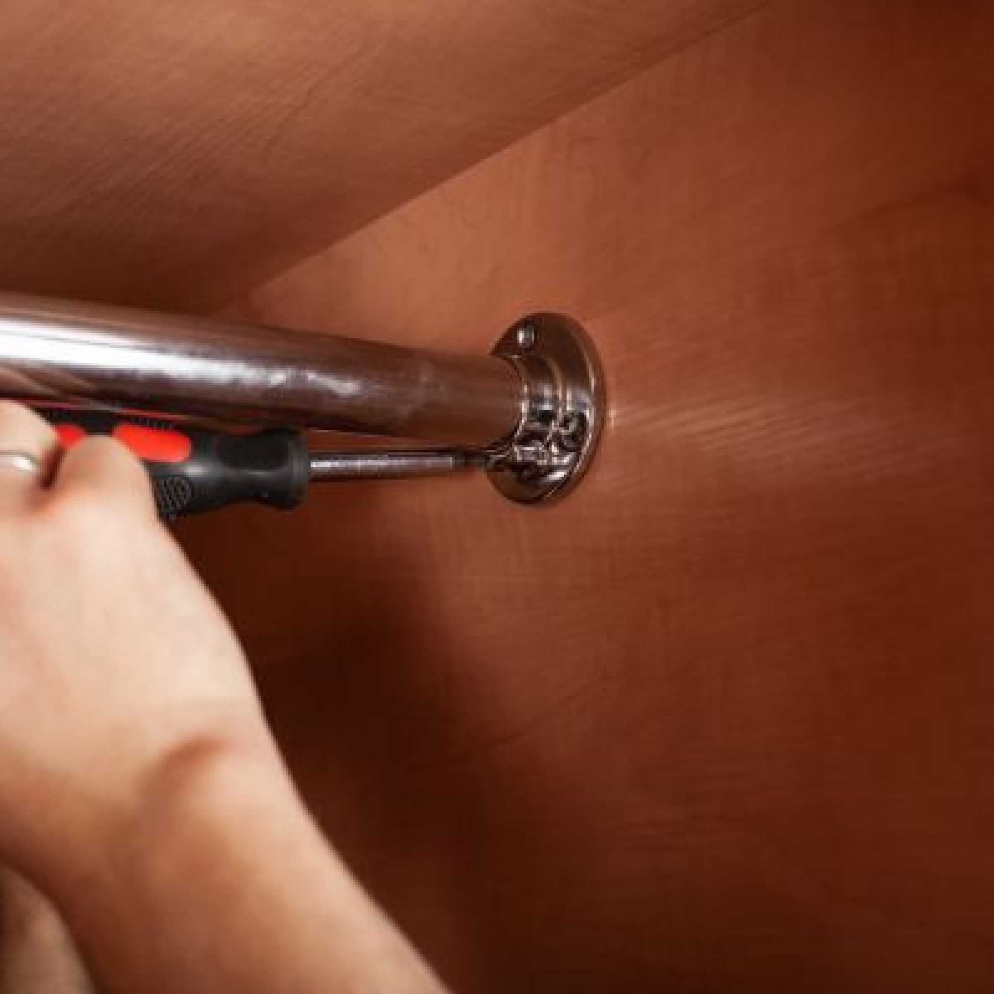 a-man-twists-a-pipe-for-a-hanger-in-a-closet-with-2025-01-08-20-40-00-utc-1